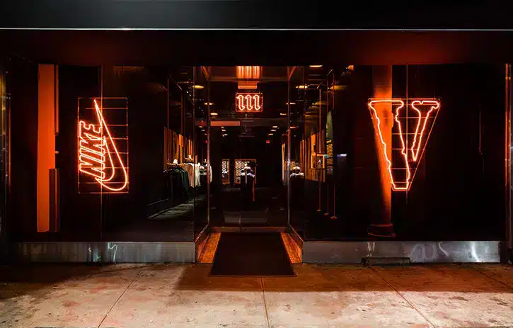 Outside of a buidling that has neon signs