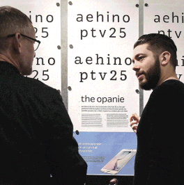 two men standing in front of text on a white board