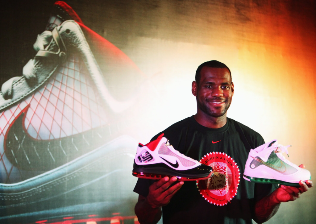 Man holding a pair of sneakers