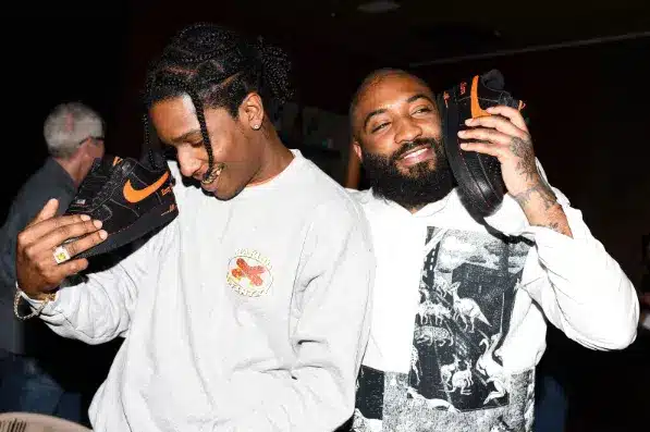 Men holding shoes to their ears like phones